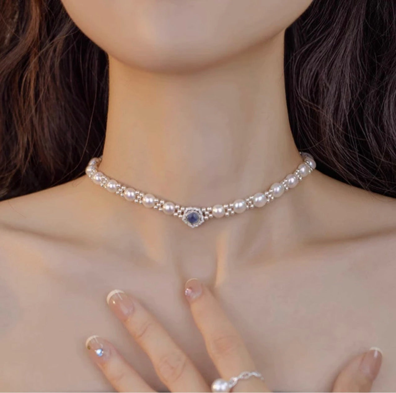 Blue stone halo pearl choker close on the neck