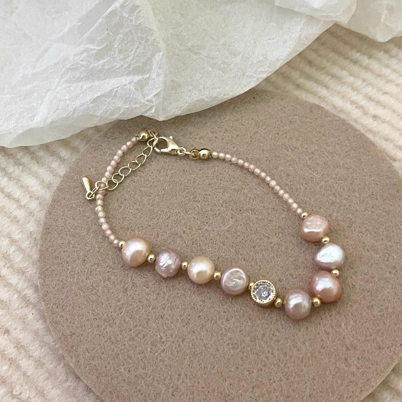 Blush baroque pearl bracelet on a felt pad