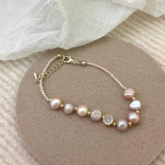 Blush baroque pearl bracelet on a felt pad