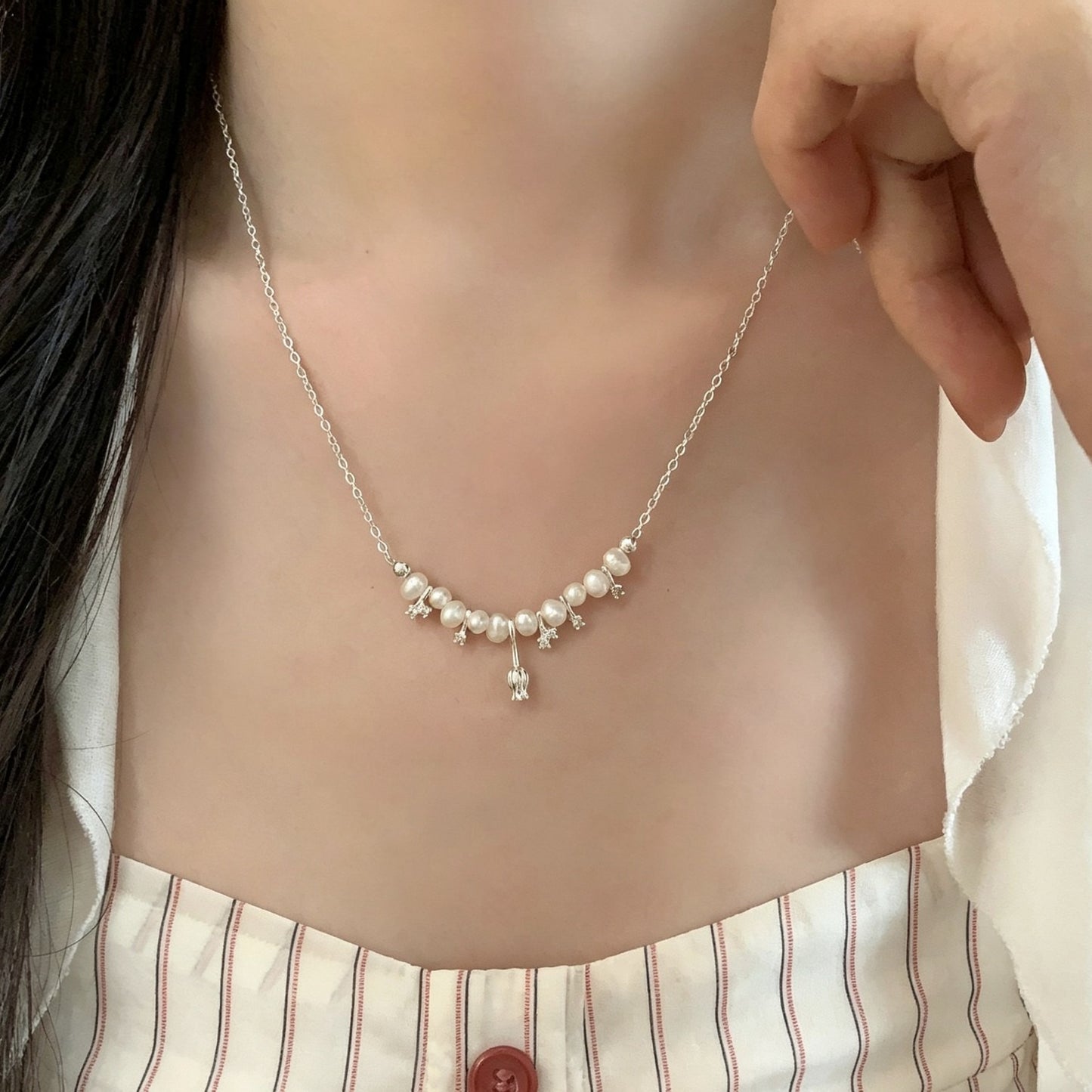 Tulip freshwater pearl necklace worn at the collarbone