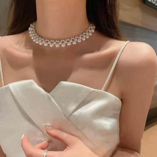 Woven pearl choker worn close to the throat