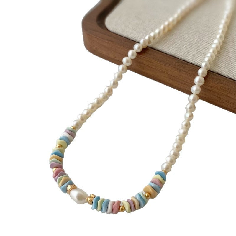 Pastel chip bead pearl necklace on a wooden tray