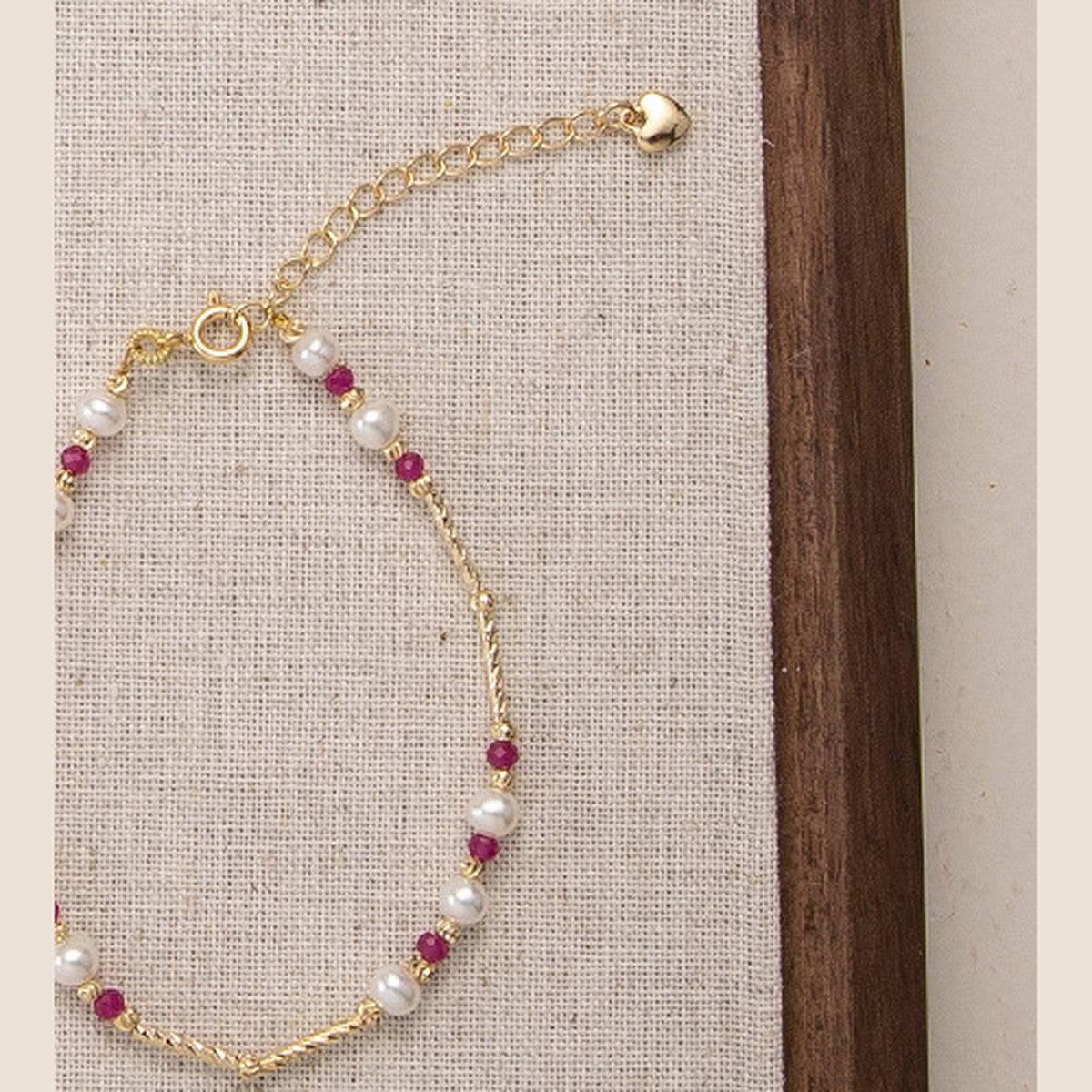 Pearl and ruby bead gold-tone bracelet with lobster clasp and heart-charm extender
