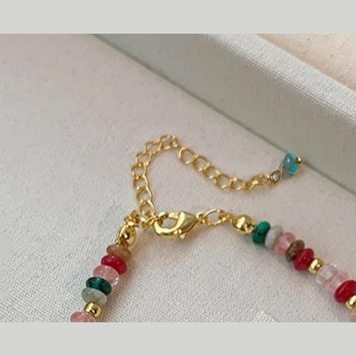 Gold-tone lobster clasp and extender on the mixed bead pearl bracelet