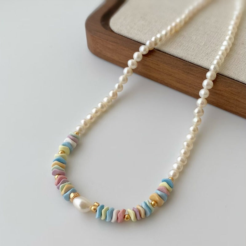Pastel chip bead pearl necklace draped on white