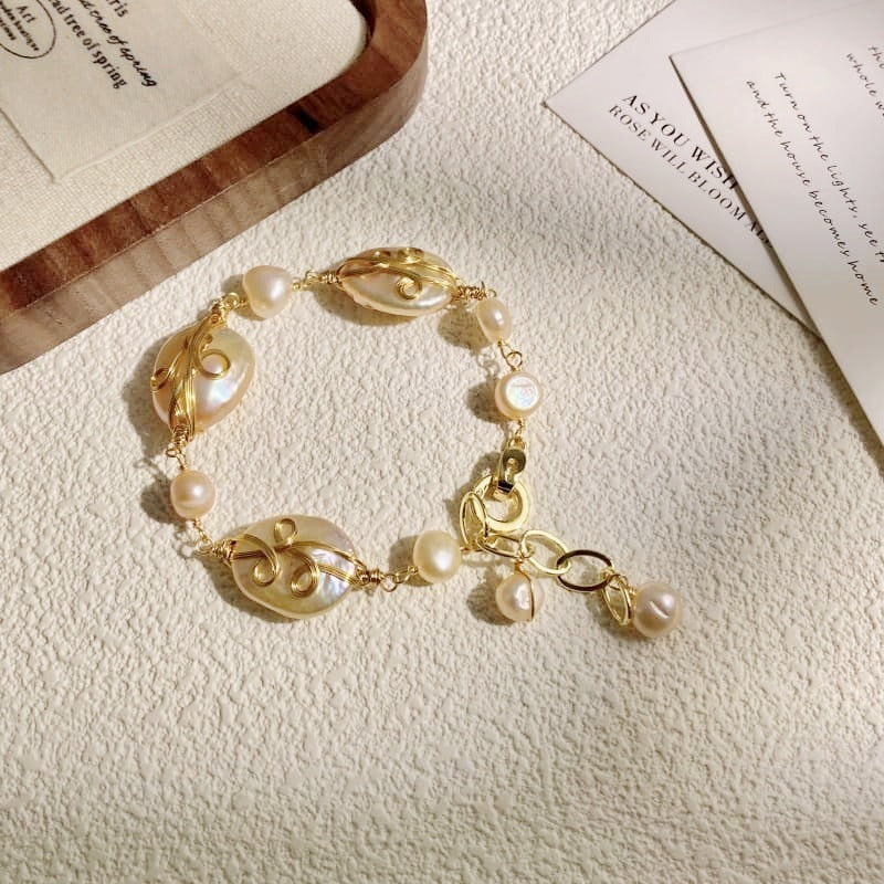 Wire-wrapped baroque coin pearl bracelet laid flat