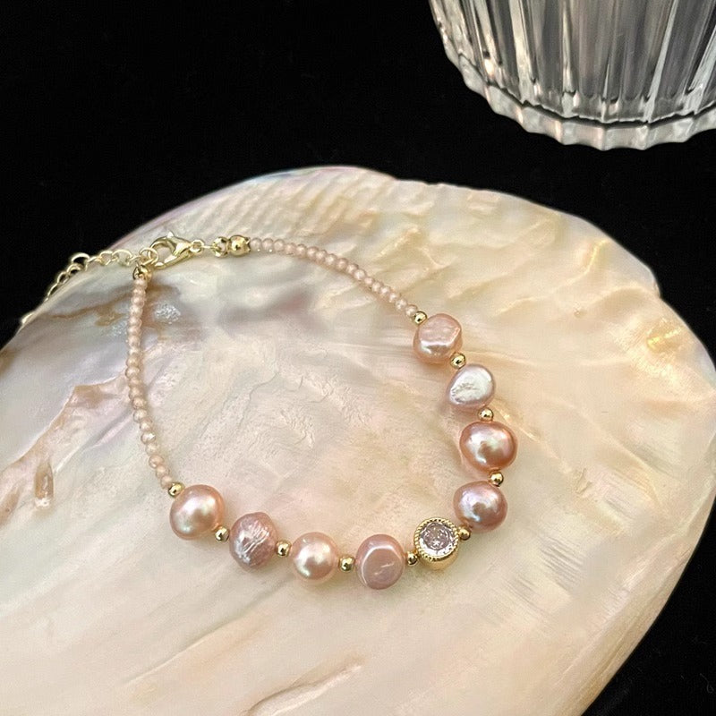 Blush baroque pearl bracelet on a shell