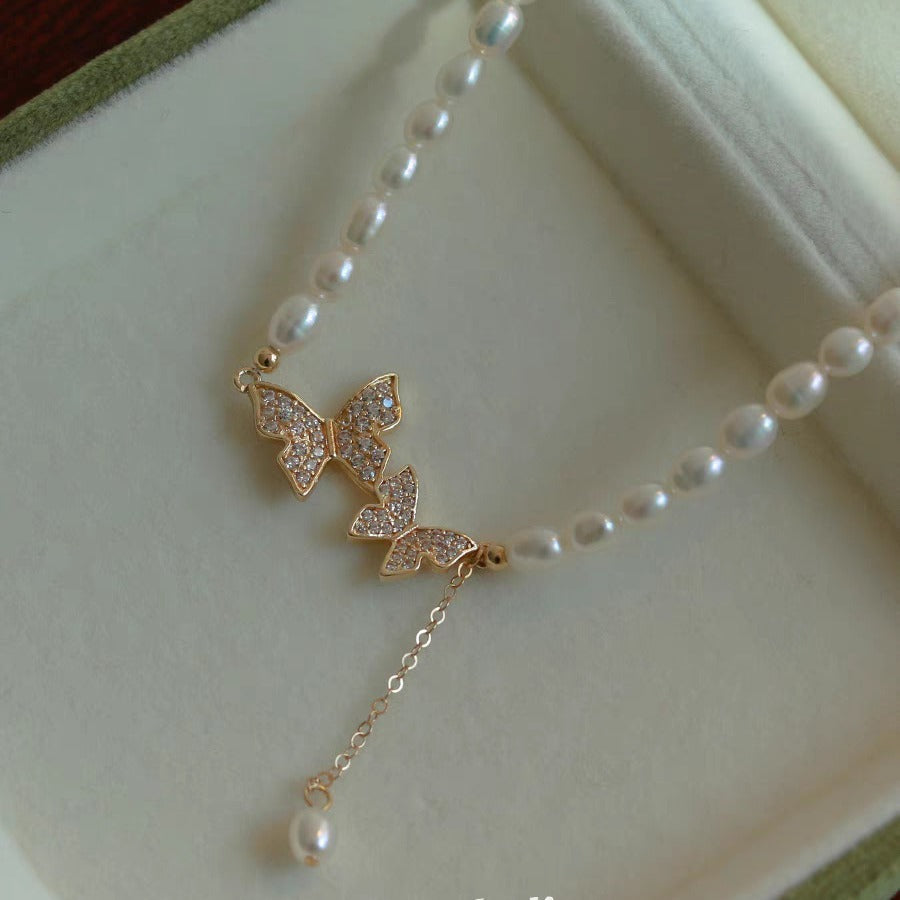 Gold-tone butterfly pearl choker in a green velvet box