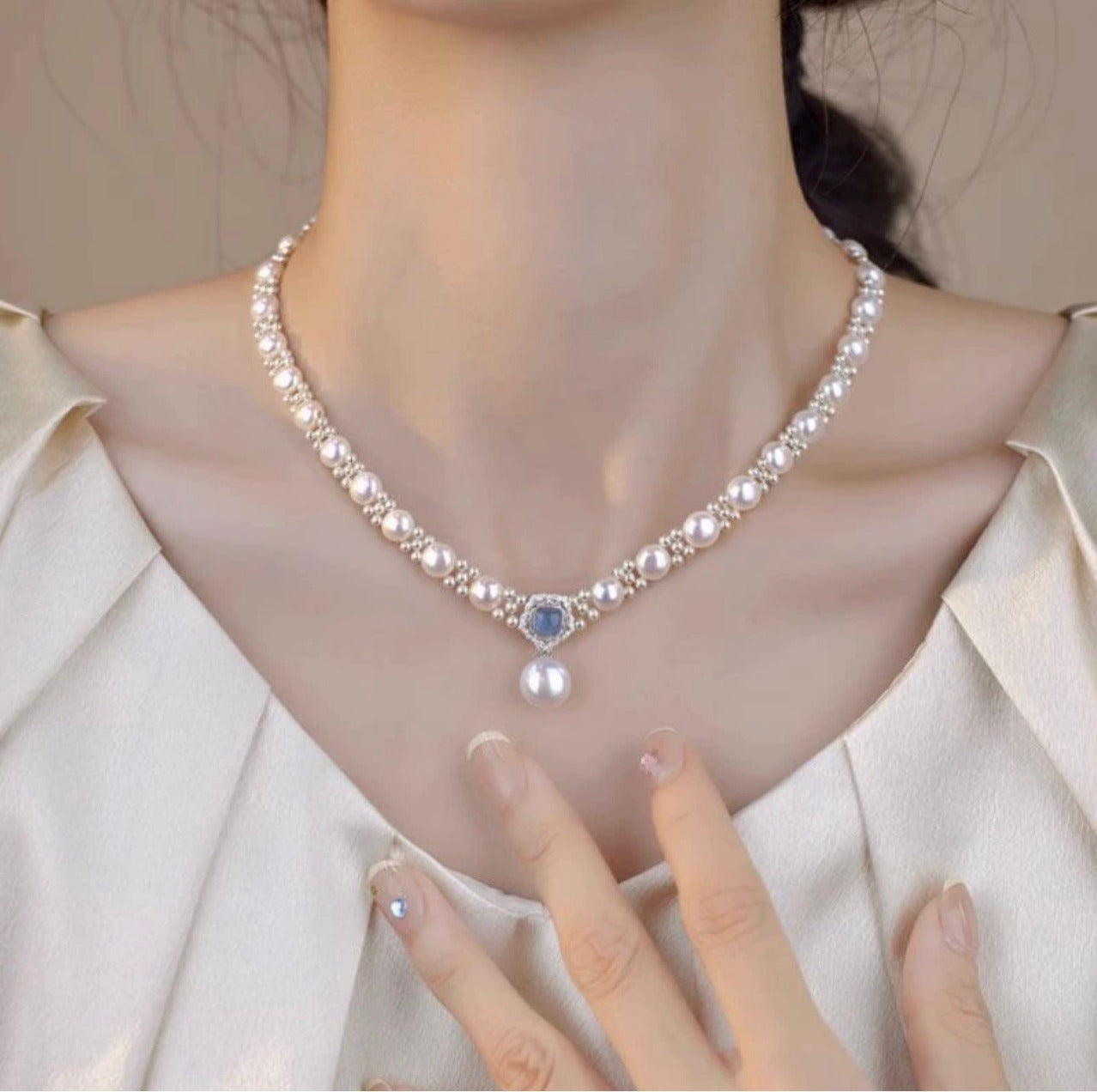 Pearl choker with blue stone halo and pearl drop