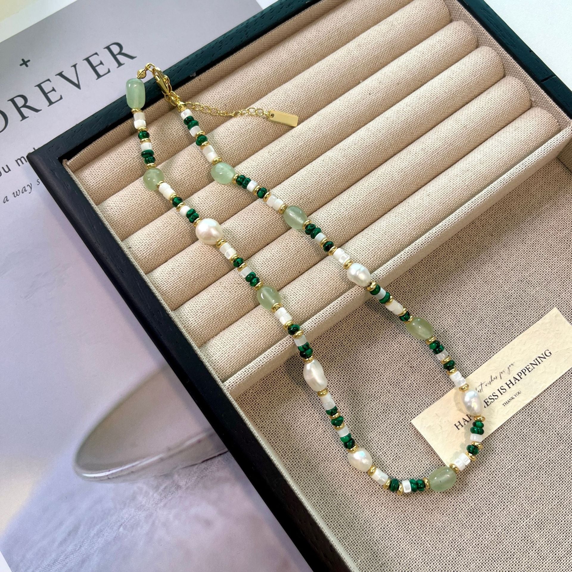Aventurine and pearl necklace in a tray