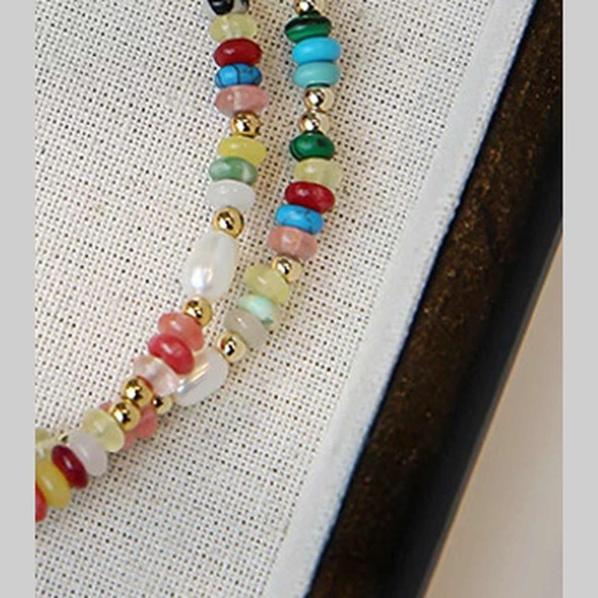 Heishi bead and freshwater rice pearl necklace on linen