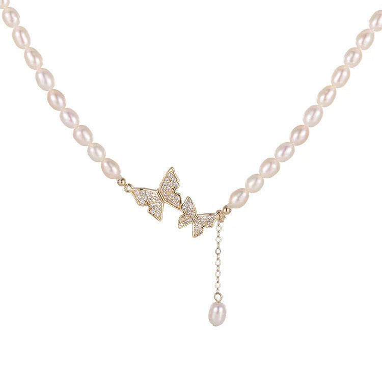 Butterfly pearl drop choker on a white background